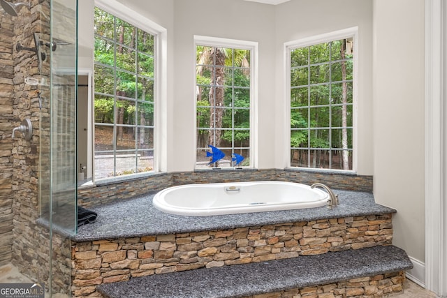 bathroom featuring a relaxing tiled tub