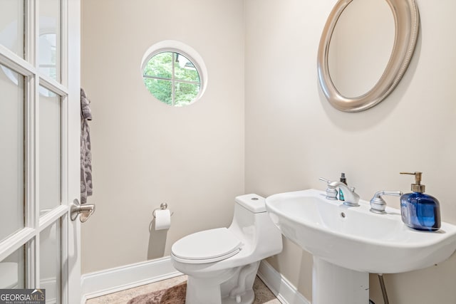 bathroom featuring sink and toilet