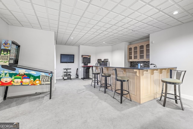 recreation room with light carpet and indoor bar