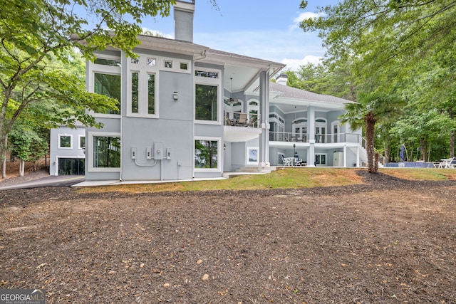 rear view of property with a balcony