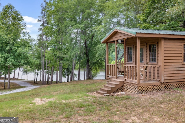 view of yard featuring an outbuilding and a water view