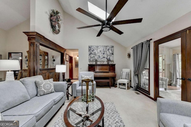 living room with ceiling fan, light colored carpet, and high vaulted ceiling