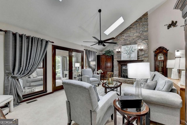 carpeted living room featuring french doors, a skylight, high vaulted ceiling, and ceiling fan