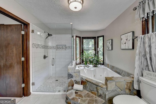 bathroom featuring tile patterned flooring, a textured ceiling, separate shower and tub, and toilet