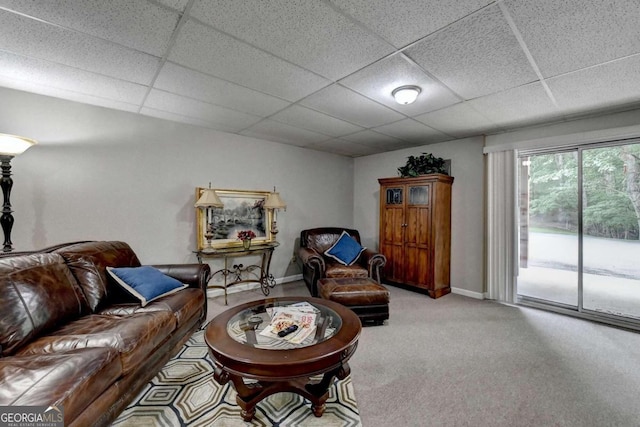 carpeted living room with a paneled ceiling