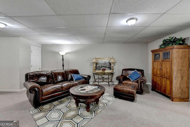 living room featuring a paneled ceiling and light carpet