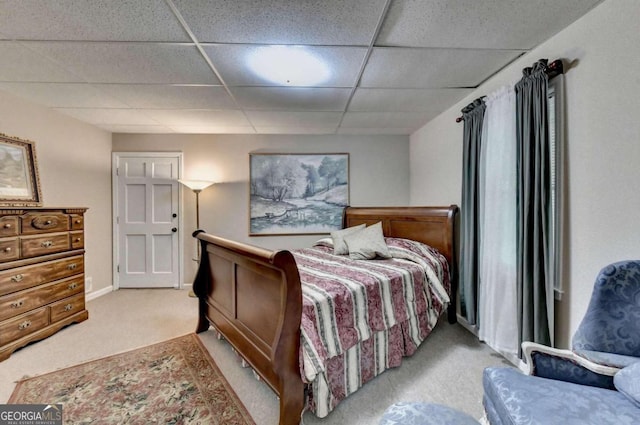 carpeted bedroom with a paneled ceiling