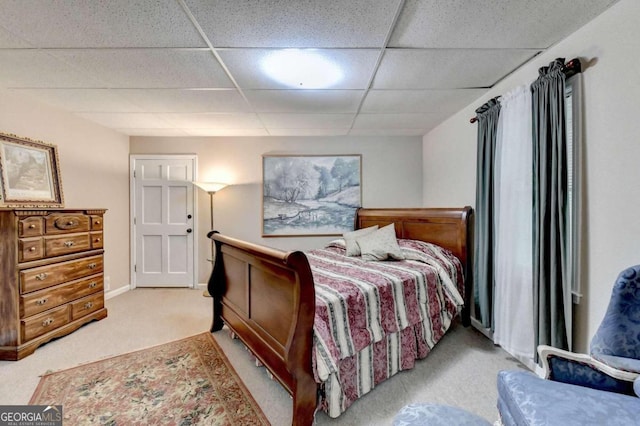 carpeted bedroom featuring a paneled ceiling