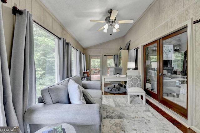 sunroom / solarium with ceiling fan and lofted ceiling