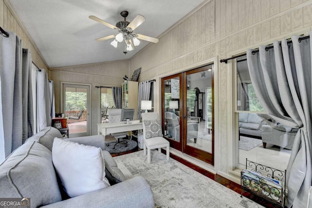 sunroom / solarium with ceiling fan, french doors, and lofted ceiling