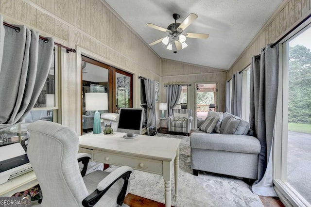 office space with ceiling fan, ornamental molding, a textured ceiling, vaulted ceiling, and hardwood / wood-style flooring