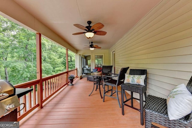 deck with ceiling fan and a grill