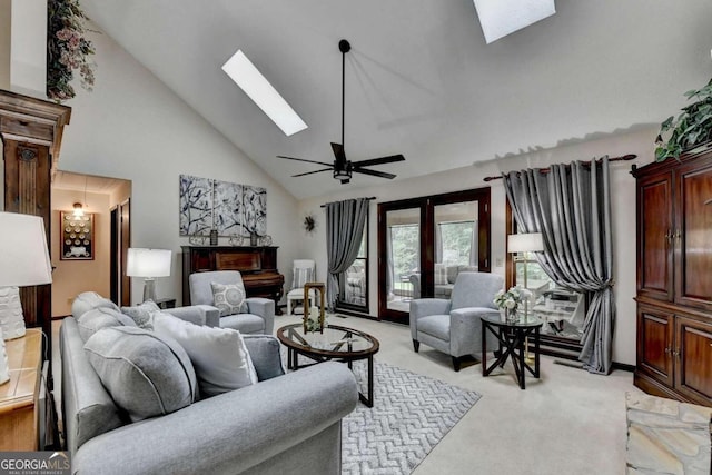 living room featuring high vaulted ceiling, french doors, a skylight, ceiling fan, and light colored carpet