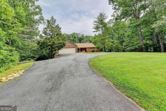 single story home featuring a front yard and a garage