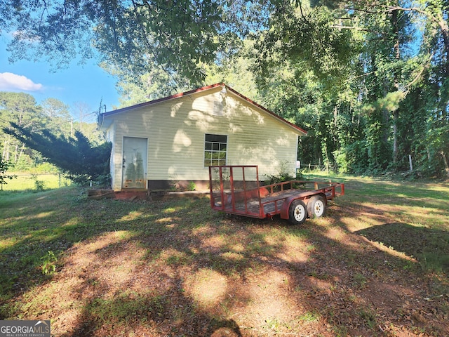 view of property exterior with a yard