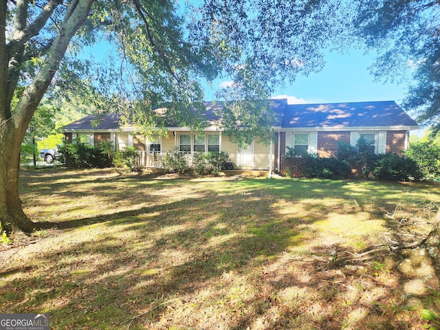 ranch-style home with a front lawn