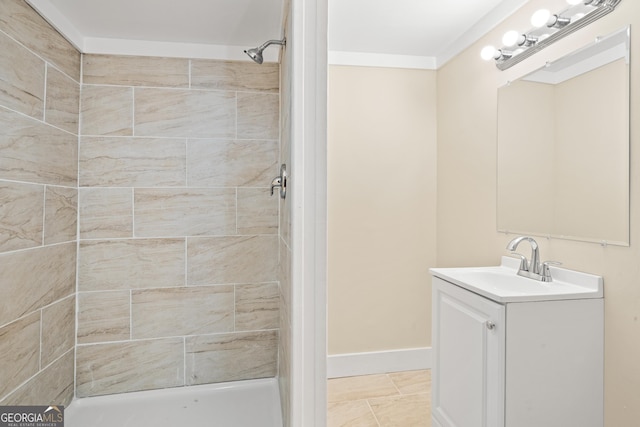 bathroom with tile patterned floors, vanity, and a tile shower