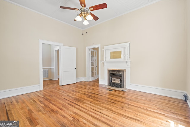 unfurnished living room with ornamental molding, ceiling fan, and light wood-type flooring