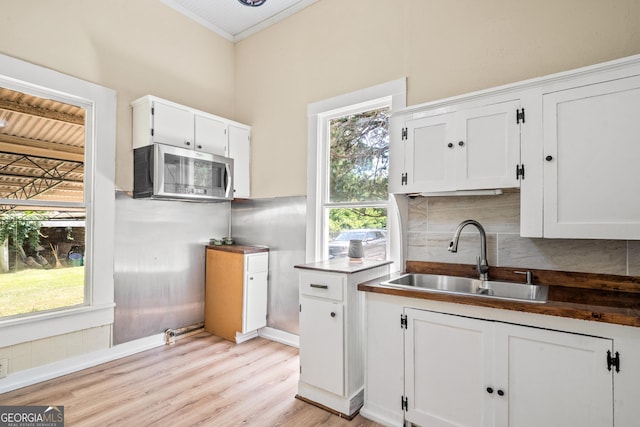 kitchen with sink, decorative backsplash, and white cabinets