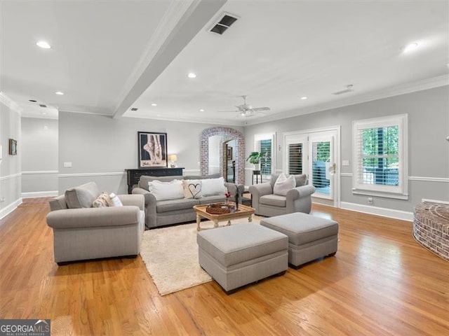 living room featuring ceiling fan, light hardwood / wood-style flooring, and ornamental molding