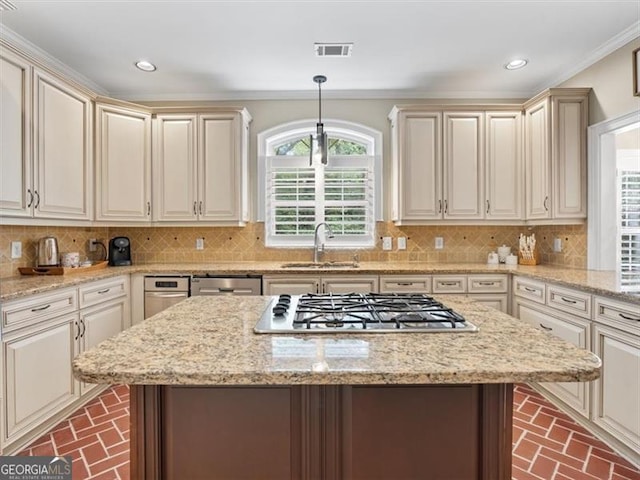 kitchen featuring sink, decorative backsplash, stainless steel gas cooktop, and light stone counters