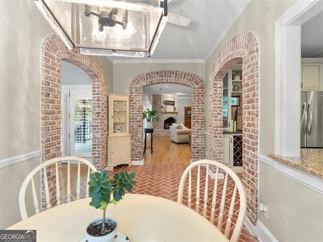 dining area with ornamental molding and light wood-type flooring