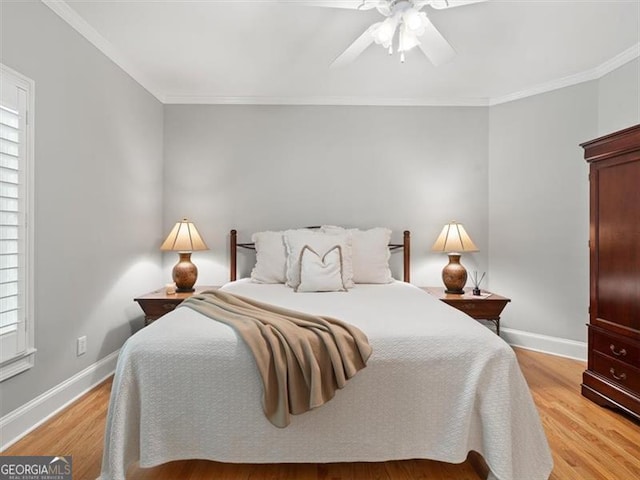 bedroom featuring ceiling fan, light hardwood / wood-style floors, multiple windows, and crown molding