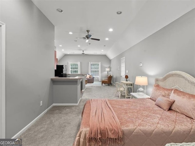 carpeted bedroom with ceiling fan, black refrigerator, and lofted ceiling