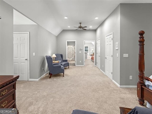 sitting room featuring light colored carpet, lofted ceiling, and ceiling fan