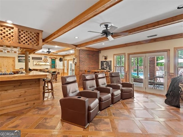 living room featuring a wealth of natural light, beam ceiling, and ceiling fan