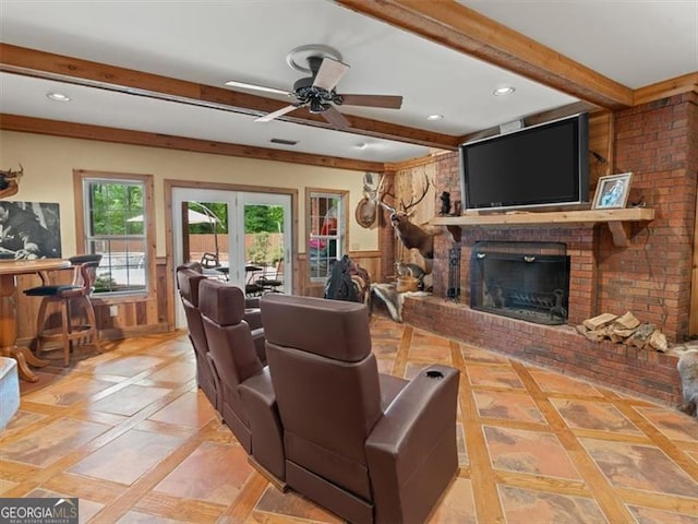 living room featuring light tile patterned flooring, a brick fireplace, beamed ceiling, french doors, and ceiling fan