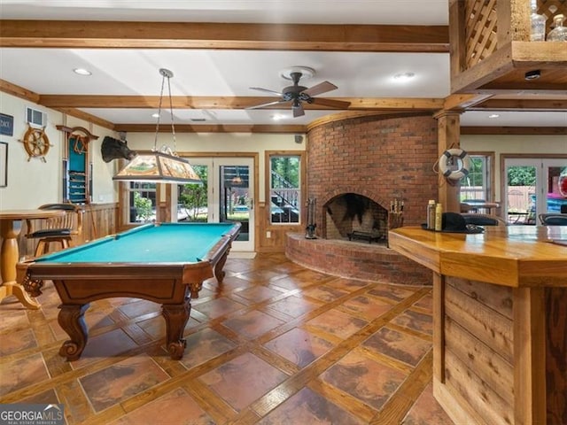 playroom with ceiling fan, plenty of natural light, a brick fireplace, and billiards