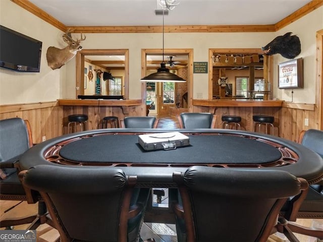 rec room with bar and crown molding