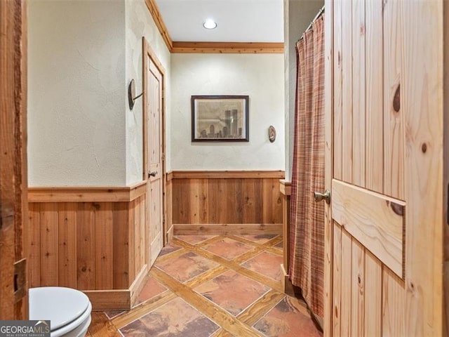 hallway featuring light tile patterned flooring and ornamental molding