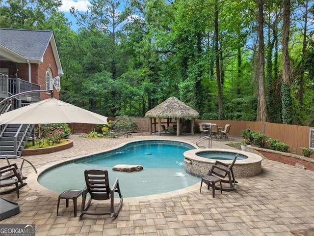 view of swimming pool featuring an in ground hot tub, a gazebo, and a patio