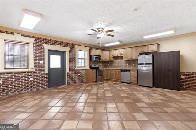 kitchen featuring light tile patterned floors, stainless steel appliances, and ceiling fan