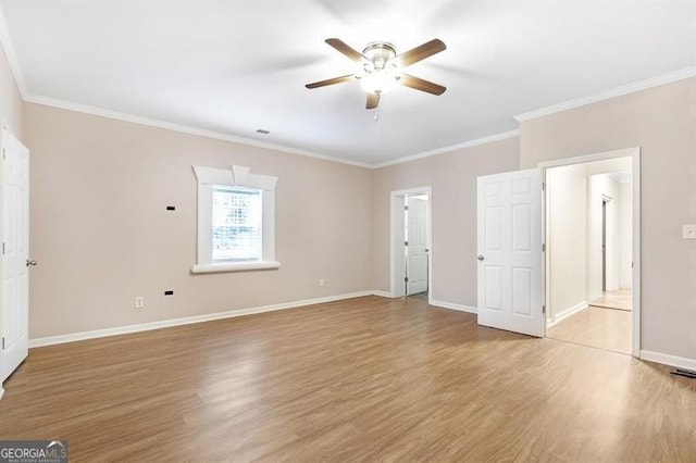 spare room with ceiling fan, light wood-type flooring, and crown molding