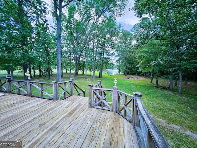 wooden terrace featuring a lawn