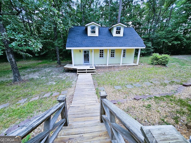 view of front of home with a porch and a front yard