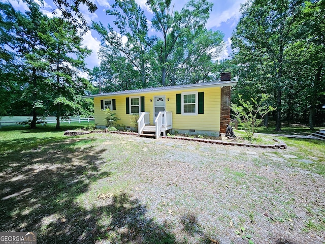 ranch-style house with a front lawn