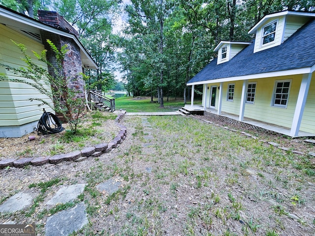 view of yard with covered porch