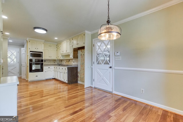 kitchen featuring ornamental molding, oven, baseboards, stainless steel microwave, and light wood-style flooring