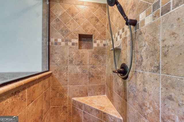 interior details with a tile shower