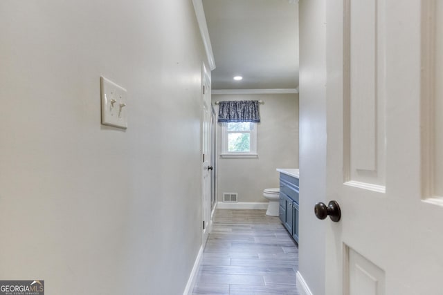 full bath with visible vents, baseboards, vanity, toilet, and ornamental molding