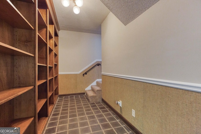 interior space featuring wainscoting and a textured ceiling