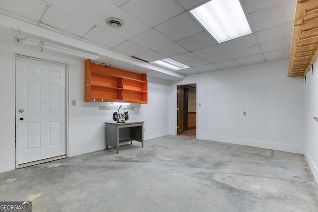 unfurnished living room with visible vents, concrete floors, and a paneled ceiling