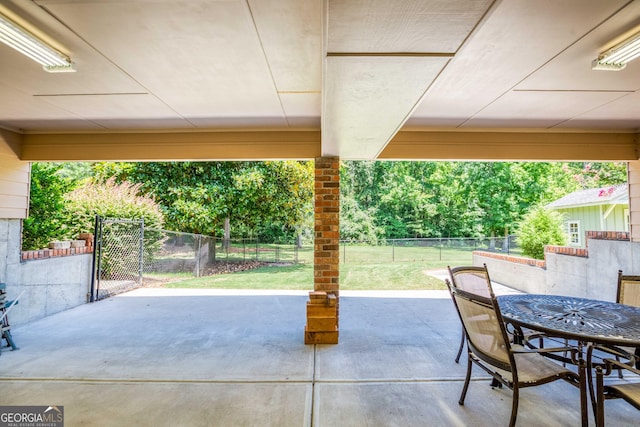 view of patio / terrace with outdoor dining area, a fenced backyard, and a gate