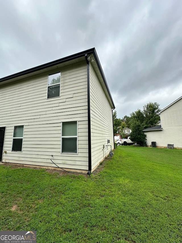 view of home's exterior with a yard