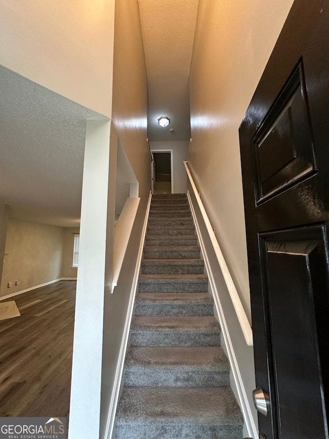 stairs featuring hardwood / wood-style flooring