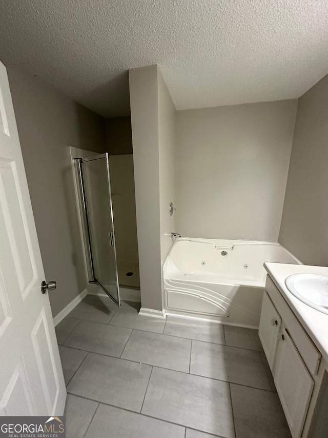 bathroom featuring tile patterned flooring, shower with separate bathtub, a textured ceiling, and vanity